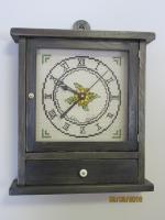 Pine wall or mantel clock with cross stitched face.