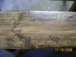 Half log bench with fish carving detail.